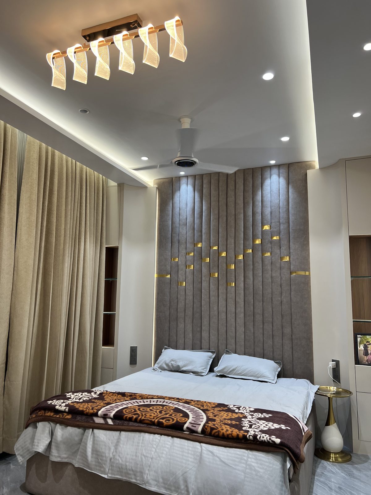 Bedroom with designer ceiling light bar, fluted headboard wall and fitted wardrobe, Udgir