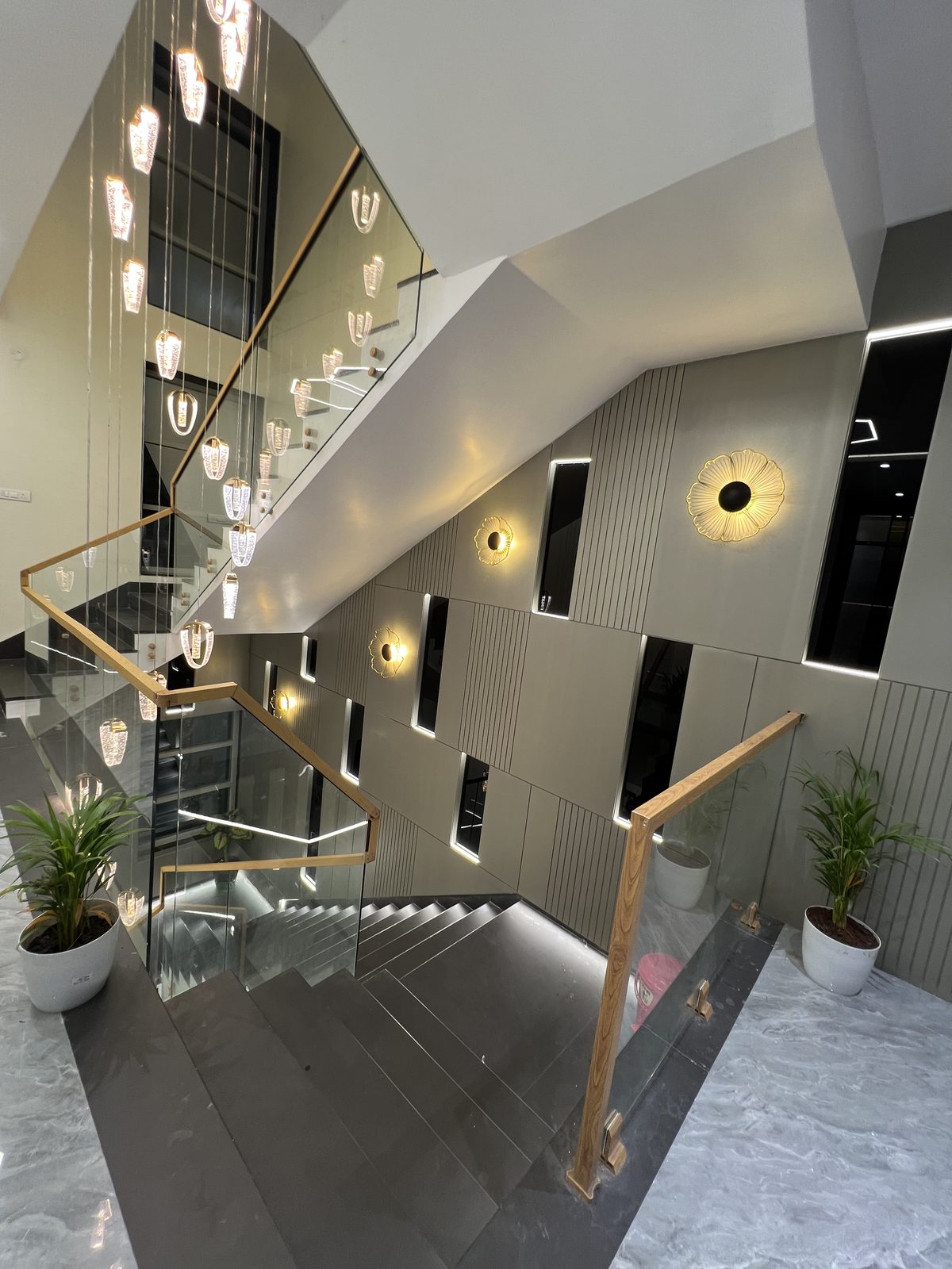 Staircase with frameless glass railing, wooden handrail and backlit stair treads, Udgir