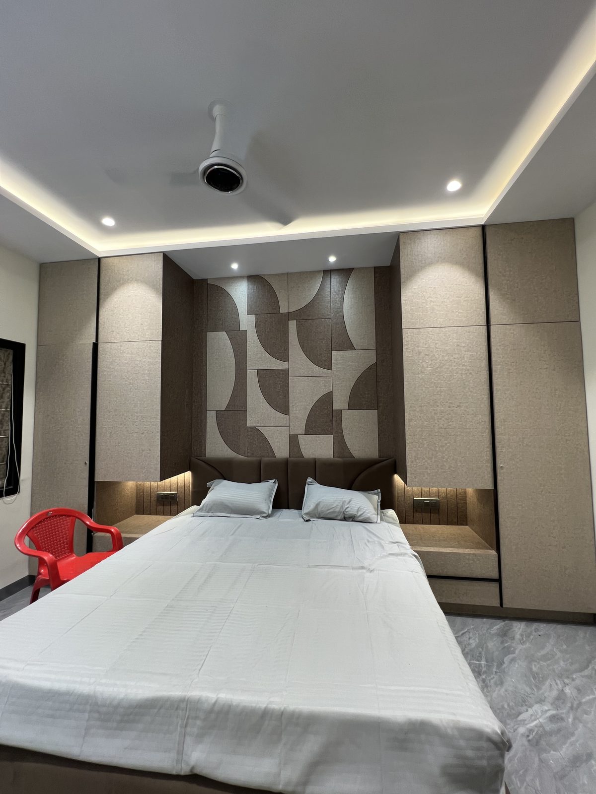 Master bedroom bed with integrated storage headboard and full height wardrobe panelling, Udgir