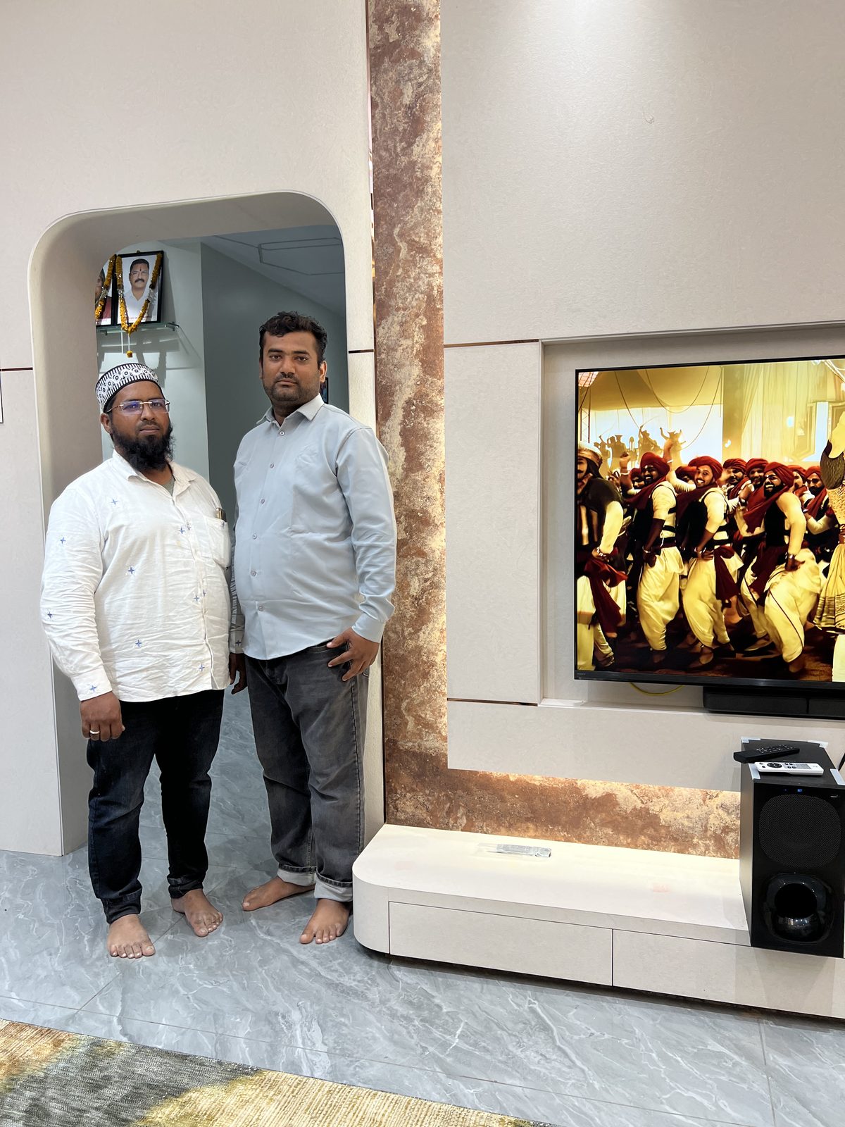 TV unit with backlit onyx panel and low storage cabinet completed in a living room, Udgir